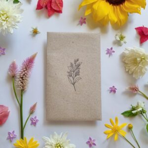 Recycled paper seed envelope with flower stamped on front