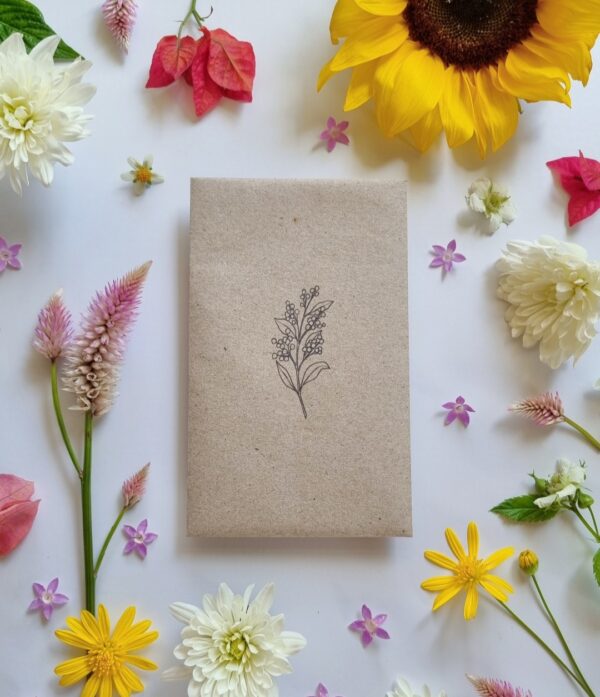 Recycled paper seed envelope with flower stamped on front